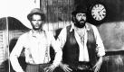 Mitte der 1970er Jahre hatten Bud Spencer (rechts) und Terence Hill eine Reihe von Prügel-Komödien gedreht, die mit ihrem rauhen Charme und dem italienischen Witz entscheidend dazu beitrugen, den europäischen Film international bekannt zu machen. In Filmen wie Die rechte und die linke Hand des Teufels und besonders dem Kassenschlager Vier Fäuste für ein Halleluja entwickelten die beiden ein bis heute kultverdächtiges Gespann: Terence Hill als junger Haudrauf und Bud Spencer als übergewichtiger Kumpeltyp mit Muckis und einem nicht versiegenden Appetit auf Bohnen.
 Foto: dpa