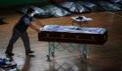Ein Mann schiebt einen Sarg in einer Turnhalle in der chilenischen Stadt Constitucion. Nach einem Erdbeben sind mindestens 700 Menschen gestorben. Foto: ap