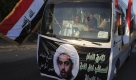 A bus is decorated with a banner showing Qais al-Khazali, leader of a militant group called Asaib Ahl al-Haq, or League of the Righteous, in Baghdad, Iraq, Saturday, Sept. 26, 2009, as 23 members of this group that was allegedly involved in kidnapping of five British contractors in Baghdad in 2007, were released today. Banner reads Qais al-Khazali, Secretary General of Asaib Ahl al-Haq. (AP Photo/Karim Kadim) Foto: ap