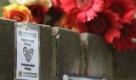 Flowers and a label are seen at the accident site of the Love Parade in Duisburg, western Germany, Sunday July 25,2010.  19 Visitors died after a stampede at the entrance of the music festival visited by more than one million people. (AP Photo/Frank Augstein) Foto: ap