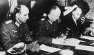 ARCHIV - Der Chef des Wehrmachtfuehrungsstabes, Generaloberst Gustaf Jodl, Mitte, unterschreibt am 7. Mai 1945 in Reims, Frankreich, die von den Alliierten vorgelegten Einzelheiten fuer die bedingungslose Kapitulation der geschlagenen deutschen Wehrmacht. Ihm zur Seite sitzen der Flottenkommandeur Generaladmiral Hans-Georg von Friedeburg, rechts, und Major Wilhelm Oxenius, links. Der Tag ist so zwiespaeltig wie kein zweiter in der deutschen Erinnerungskultur: Im Westen wurde der 8. Mai 1945 lange Zeit vor allem als Symbol von Niederlage und Kapitulation verstanden. Heute sprechen Demokraten jedoch allgemein vom 'Tag der Befreiung' - der Befreiung vom Wahnsinn der Hitler-Zeit und vom Schrecken des Krieges.   (AP Photo/Archiv) ** NUR S/W ** ** zu unserem KORR. ** --- FILE - Conquest of Europe - Terms of unconditional surrender imposed by the allies on the beaten Wehrmacht are signed by Col.Gen. Alfred Jodl, Nazi Chief of Staff, as Maj. Wilhelm Oxenius, his side, left, and Gen. Adm. Hans-George von Friedeburg, right, Commander in Chief of German fleet, look on glumly. The Chief of Staff signed the document at SHAFF headquarters in Rheimes, France, on May 7, 1945. (AP Photo/File) ** B/W ONLY ** Foto: ap