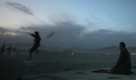 Internally displaced Afghan boys play football as an Afghan man offers evening prayers at a refugee camp in Kabul, Afghanistan, Monday, Oct. 26, 2009. According to UNHCR some 2.7 million registered Afghans refugees still remain in Pakistan and Iran. (AP Photo/Altaf Qadri) Foto: ap