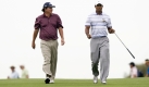 Jason Dufner, left, from the United States walks with compatriot Tiger Woods on the 16th fairway during the third round of the Australian Masters golf tournament at the Kingston Heath Golf Club in Melbourne, Australia, Saturday, Nov. 14, 2009. Woods finished the round at 10 under par while Dufner was at 8 under. (AP Photo/Andrew Brownbill) Foto: ap