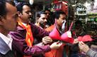 Anhänger der radikalen hinduistischen Organisation Bajrang Dal entfernen Damenunterwäsche aus dem Schaufenster eines Geschäftes im indischen Bhopal. Die Aktivisten sind gegen Reklamewände oder anstößige Damenunterwäsche, da sie nicht Teil der indische Kultur seien.
 Foto: dpa