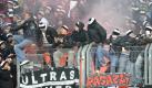 Beim Match zwischen dem 1. FC Nürnberg und Eintracht Frankfurt sitzen einige Fans auf einem Absperrgitter. Foto: AP