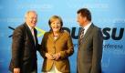 Bundeskanzlerin Angela Merkel (CDU), der hessische CDU-Fraktionsvorsitzende Christean Wagner (links) und der bayerische CSU-Fraktionsvorsitzende Georg Schmid stehen in der Oldtimerwerkstatt von Opel in Rüsselsheim vor Beginn einer Konferenz der Fraktionsvorsitzenden von CDU/ CSU zusammen. Die Fraktionsvorsitzenden und die Kanzlerin trafen sich bei dem angeschlagenen Autobauer zu einer Strategie-Konferenz.  Foto: ddp