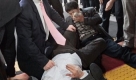 Kang Ki-jeong, bottom, and Choi Jae-seong, top left, lawmakers of the main opposition Democratic Party, react after scuffling with Parliament security officials at the National Assembly in Seoul, South Korea, Saturday, Jan. 3, 2009. Lawmakers scuffled with security guards when the guards moved in to forcibly remove opposition legislators who had been camped out in parliament for nine days in a standoff with President Lee Myung-bak's ruling party. (AP Photo/Ahn Young-joon) Foto: ap
