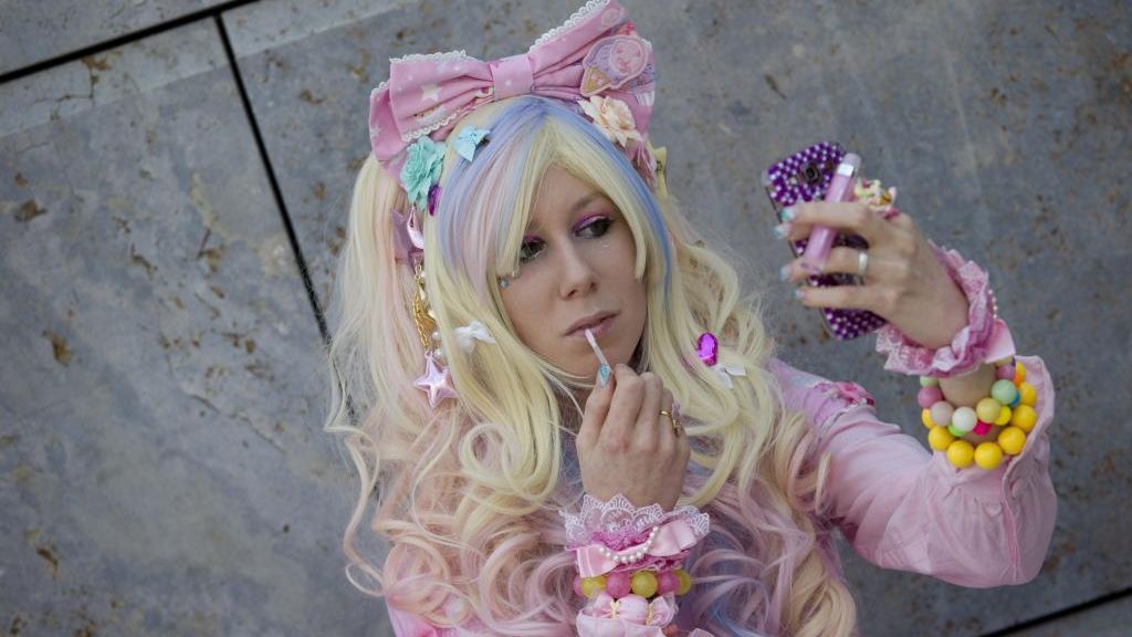 Barbie-Girl: Eine als Comic-Charakter verkleidete Cosplayerin schminkt sich vor dem großen Auftritt die Lippen nach. (Foto)