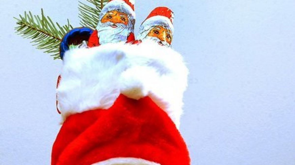 Ein mit Süßigkeiten gefüllter und mit Tannengrün geschmückter Nikolausstiefel. (Foto)