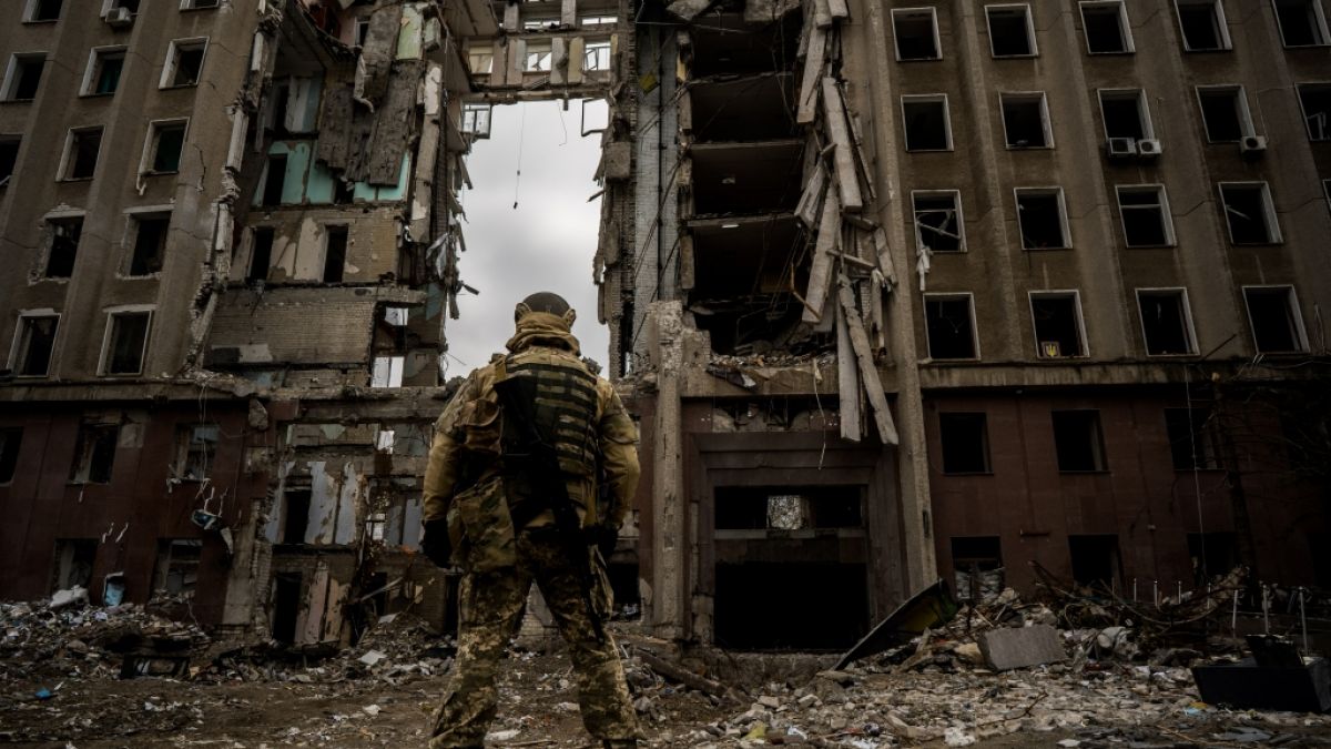 Ein ukrainischer Soldat vor einem zerstörten Gebäude. (Foto)