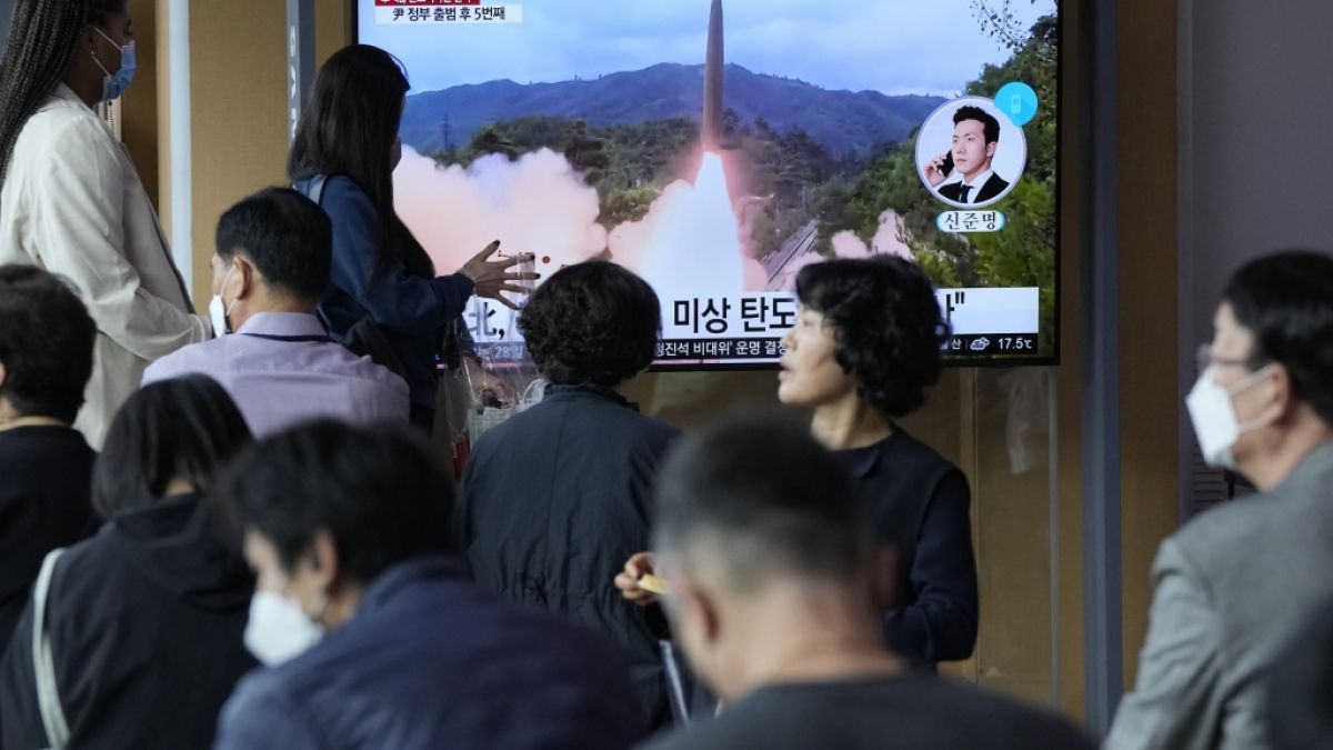 Menschen sehen sich eine Nachrichtensendung an, die ein Bild eines nordkoreanischen Raketenstarts zeigt. (Foto)