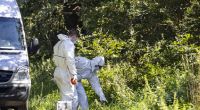 Beamte der Spurensicherung untersuchen den Auffindeort einer weiblichen Leiche nahe einer Tankstelle unmittelbar an der deutsch-niederländischen Grenze.