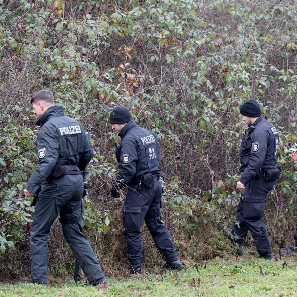 In unmittelbarer Nähe des Fundortes des getöteten achtjährigen Fabian aus Güstrow durchsuchen Polizisten Buschwerk am Wegesrand.