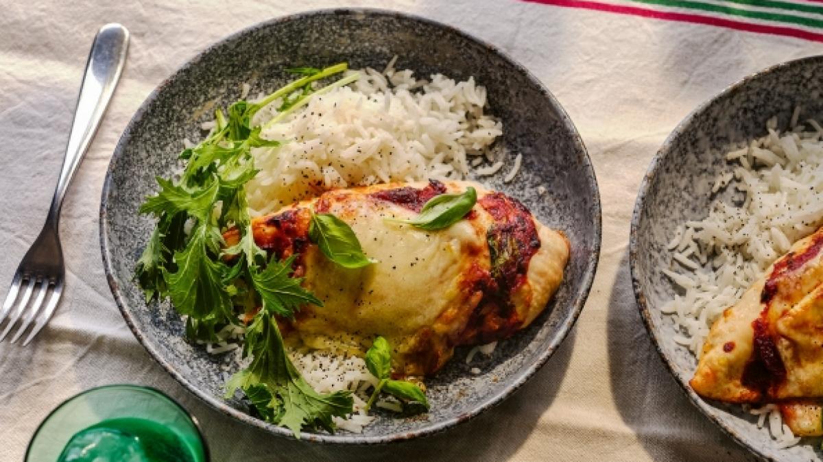 Pollo alla pizzaiola con mozzarella filante: H&auml;hnchenbrustfilets in Tomatensauce mit geschmolzenem Mozzarella. (Foto)