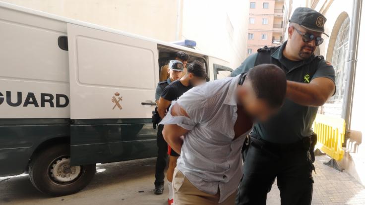 Einer der Tatverdächtigen wird von der Guardia Civil ins Gericht geführt.
