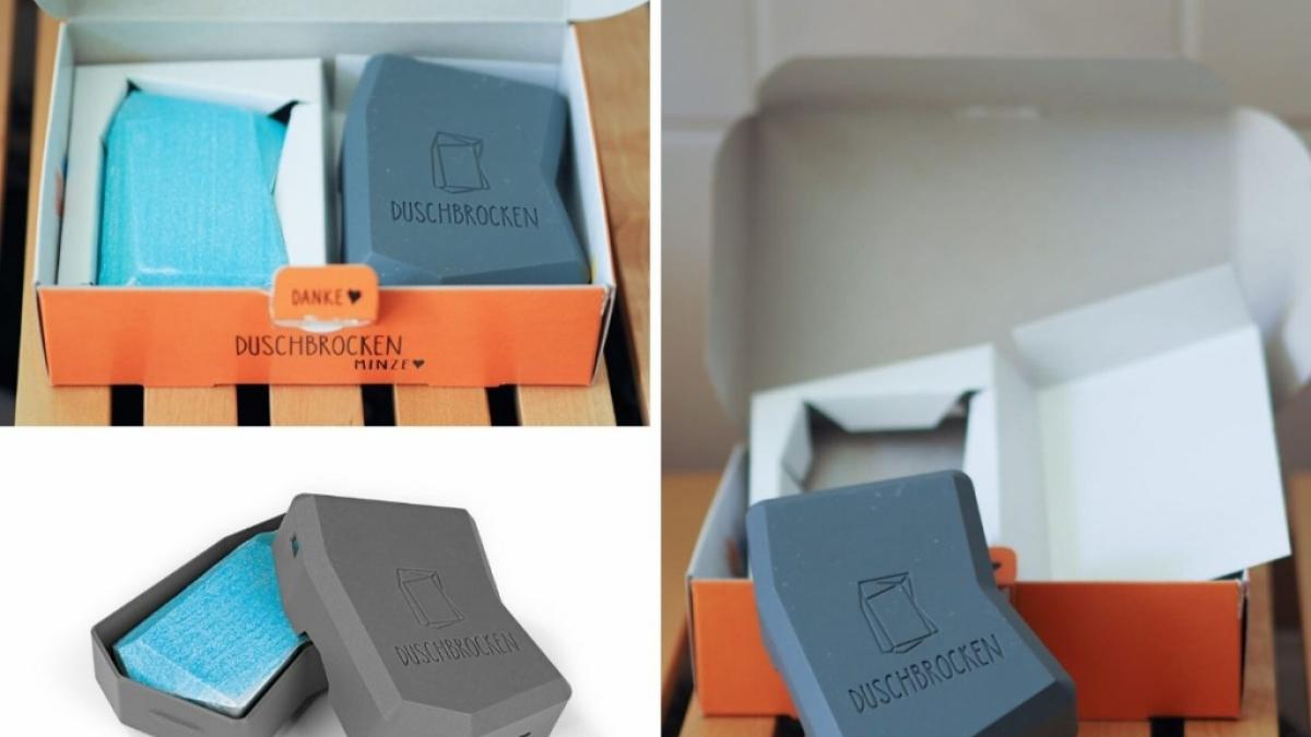 Der Duschbrocken ist in einem Pappkarton verpackt. (Foto)