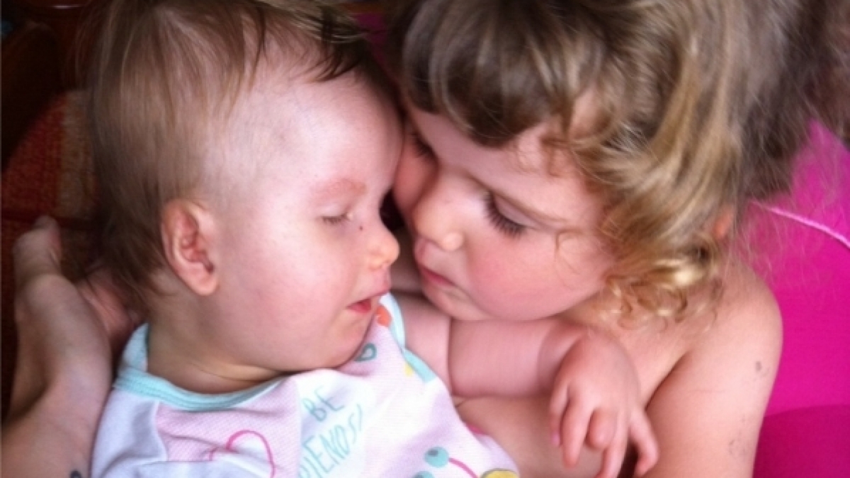 Die dreij&auml;hrige Tochter k&uuml;mmert sich r&uuml;hrend um ihre kleine Schwester. (Foto)
