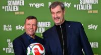 Markus Söder (r.) neben Rekordnationalspieler Lothar Matthäus in München bei der Premiere einer neuen Doku über die Fußball-WM 1990.