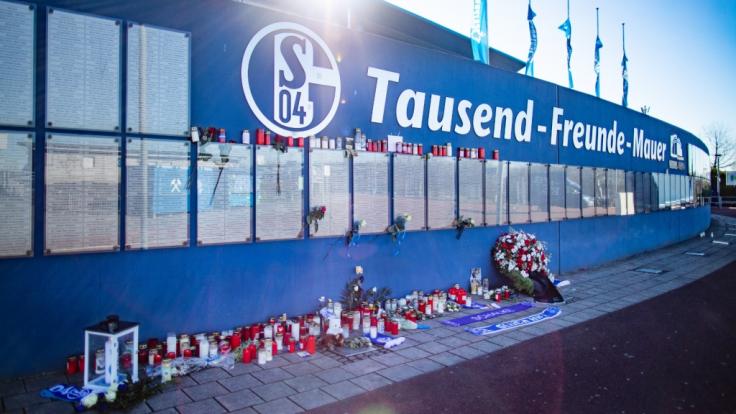 Zahlreiche Trauerkerzen stehen an der Tausend-Freunde-Mauer vor der Veltins Arena.