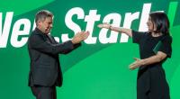 Als Robert Habeck seine Parteikollegin Annalena Baerbock umarmen will, verheddert sich der grüne Wollfaden an Baerbocks High Heels.