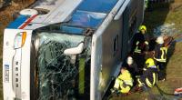 Einsatzkräfte installieren zum Aufrichten des verunglückten Schulbusses Hebekissen.
