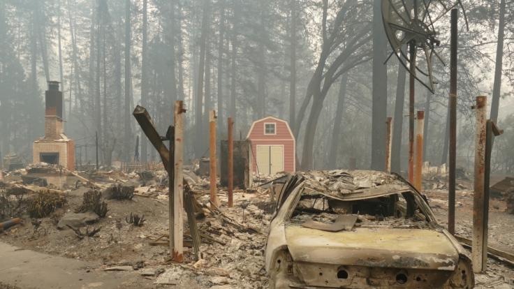 USA, Paradise: Ein ausgebrannter Pkw und Trümmer nach dem Waldbrand, dem sogenannten