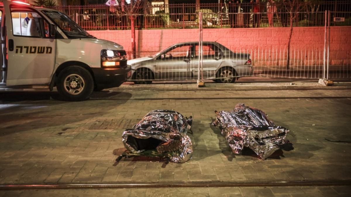 Zwei durch Sch&uuml;sse get&ouml;tetes Opfer liegen abgedeckt in der N&auml;he einer Synagoge. In einer israelischen Siedlung in Ost-Jerusalem sind mehrere Menschen durch Sch&uuml;sse get&ouml;tet worden. (Foto)