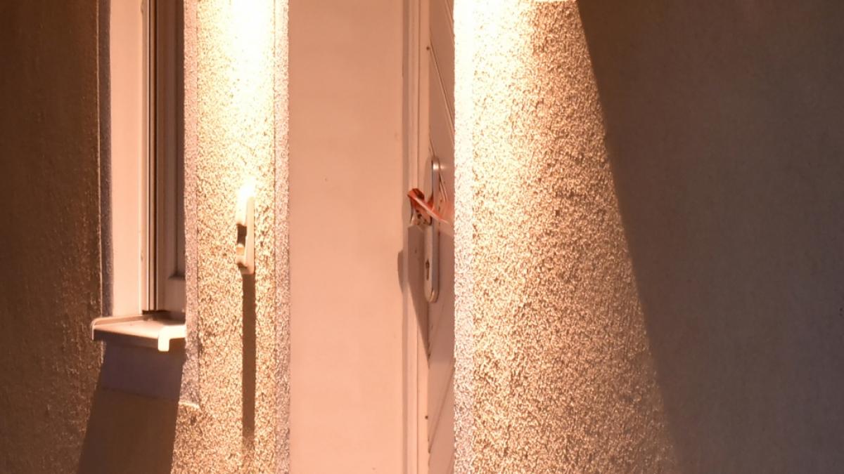 An dem T&uuml;rgriff der Eingangst&uuml;r von einem Einfamilienhaus ist Absperrband zu sehen. (Foto)