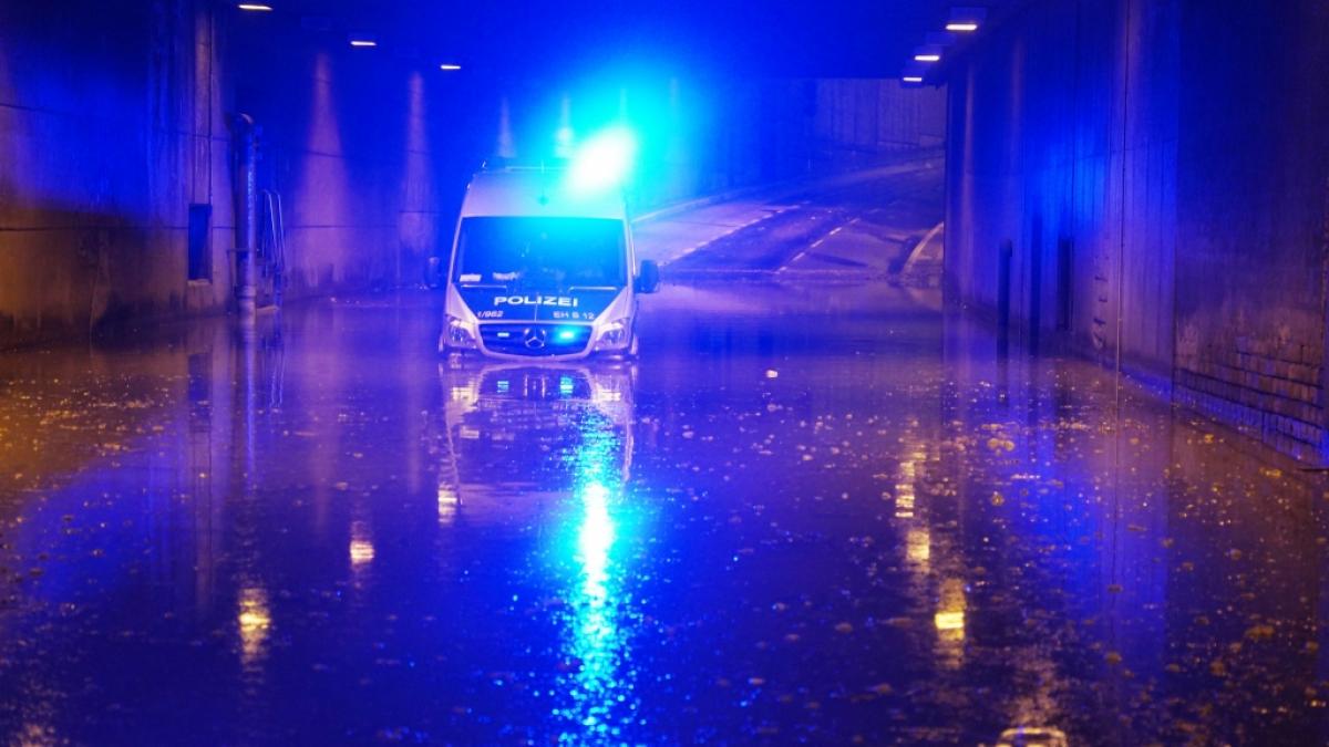 Ein Polizeifahrzeug blinkt noch mit Blaulicht, nachdem es in einer &uuml;berschwemmten Unterf&uuml;hrung in Stuttgart liegen geblieben ist. (Foto)